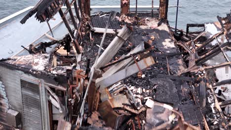 Oceanside-California-Pier-Fire-Damage-Former-Ruby's-Diner-Drone-Bakwards-reveal-shot-rear-of-building-to-trenched-cutout-of-pier