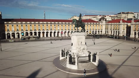 Lisbon,-Commercial-Square-King-Jose's-statue's-drone-footage-getting-closer-from-right-side-with-perfect-angle-than-the-camera-turns-towards-Rua-Agusta-Arc-on-a-sunny-day-with-blue-skies