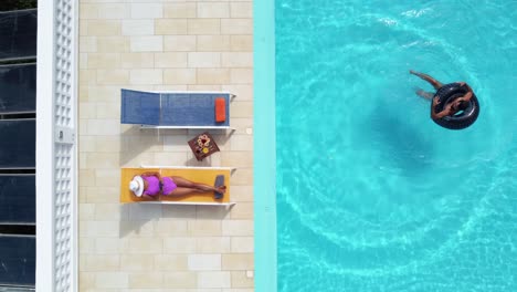 Top-View-of-Couple-Enjoying-Resort-Swimming-Pool-During-Summer-Vacations