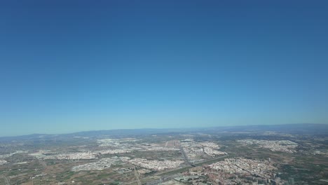 Hyperlapse-Valencia-city,-Spain,-shot-from-a-plane-arriving-to-the-airport-in-a-splendid-sunny-spring-morning