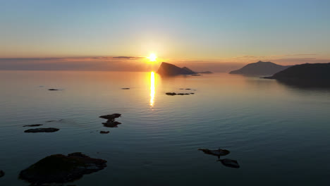 Midnight-sun-and-calm-sea,-serene-summer-night,-in-Northern-Norway---Aerial-view