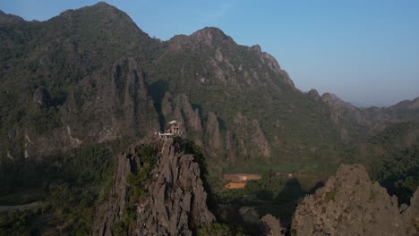 drone-shot-of-jagged-cliffs-in-mountain-valley-in-Vang-Vieng,-the-adventure-capital-of-Laos