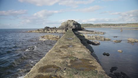 Man-made-stone-pier,-ocean-water-motion,-coastline-scenery,-Scotland