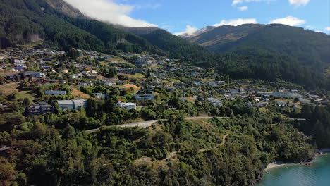 Queenstown-Bay-and-port-overlooking-Lake-Wakatipu,-South-Island-New-Zealand---push-in-aerial