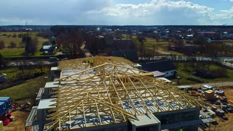 Aerial-view-circling-a-wooden-roof-frame-construction-of-a-suburban-condo