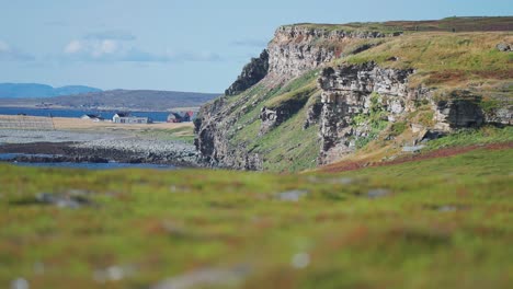 Withered-cliffs-covered-with-soft-grass-tower-above-the-coast