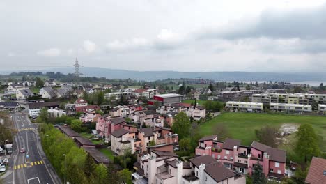 Pink-houses-and-buildings-in-suburb-of-swiss-town-and-Lake-Zurich-in-background