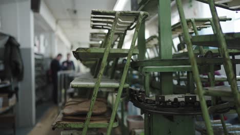 Conveyor-belt-system-transporting-handcrafted-sandals-in-a-shoe-workshop