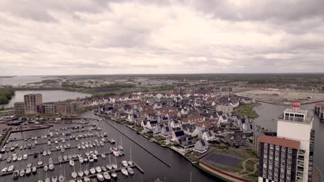 Aerial-descend-revealing-De-Knar-recreational-port-at-the-Veluwemeer-with-pleasure-boats-and-lighthouse