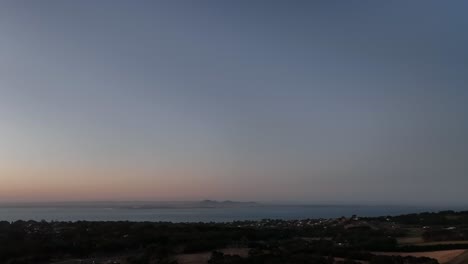 Drone-shot-towards-mountains-at-sunset