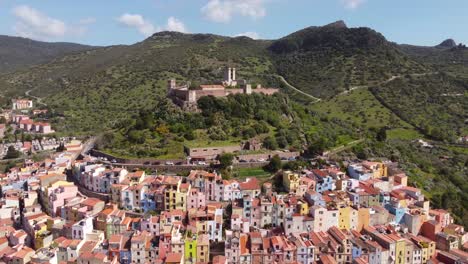 A-breathtaking-aerial-perspective-captures-the-enchanting-castle-and-historic-town-of-Bosa,-Sardinia