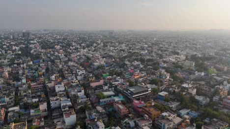 A-sweeping-drone-footage-capturing-the-dynamic-energy-of-Chennai's-urban-landscape,-with-clouds-adding-depth-and-drama-to-the-scene