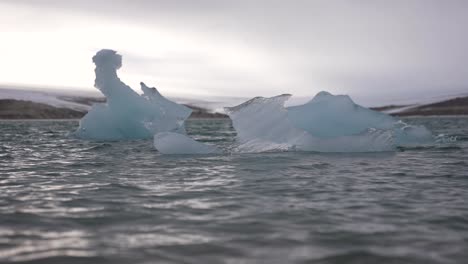 Slow-Motion,-Cold-Sea-Waves-Around-Pieces-of-Ice-Floating-Under-Glacier