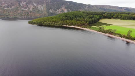 Aerial-View-Of-Loch-Ness-Beach-With-Mountain-Landscape-In-Background