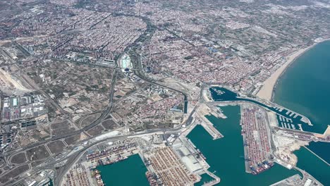 High-altitude-aerial-full-view-of-Valencia-City-in-SE-Spain-in-a-splendid-sunny-morning,-shot-from-a-plane-cockpit-departing-from-the-airport