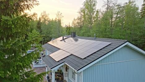 Aerial-view-away-from-rooftop-solar-cells-absorbing-the-last-sunlight-of-the-day