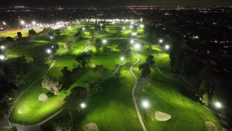 Aerial-video-of-a-lit-golf-course-at-night