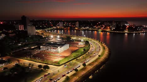 Aerial-forward-shot-of-Posadas-city-scape-at-night,-Argentina