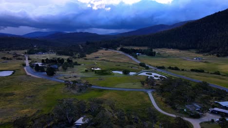 Dramatic-storm-clouds-above-Kosciuszko-National-Park-with-rural-farms-and-highway-in-foreground,-Crackenback,-NSW,-Australia