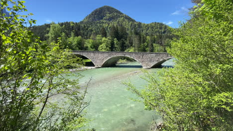 Scenic-summer-landscape-in-the-Bavarian-Alps-with-beautiful-bridge-and-river-close-to-the-village-of-Ramsau,-cars-crossing,-Nationalpark-Berchtesgadener-Land,-Bavaria,-Germany