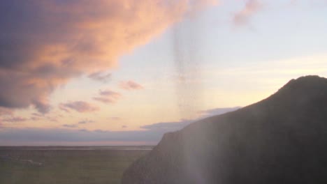 Bunte-Wolken-Und-Ein-Wasserfall-In-Island---Zeitlupe