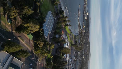 Vertical-drone-shot-of-Suburb-district-of-Esperance-Town-and-port-in-background-at-sunset-time,-Western-Australia