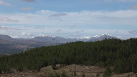 Slow-panning-shot-of-snowy-munros-beside-each-other-in-the-Scottish-Highlands