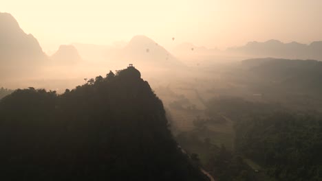 golden-sunrise-behind-cliffs-in-Vang-Vieng,-the-adventure-capital-of-Laos