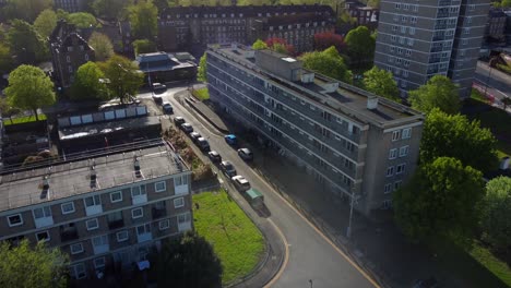 Drone-flying-over-streets-and-council-housing-estate-in-urban-London