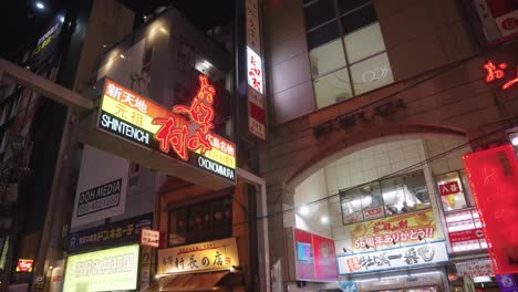 Slow-motion-Pan-establishing-shot-at-night-at-Hiroshima-Shintenchi-Street-and-Okonomimura-Food-Street-at-Night-in-Japan
