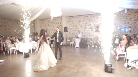 Static-shot-of-a-bride-and-groom's-first-dance-ending-with-pyrotechnics-dying
