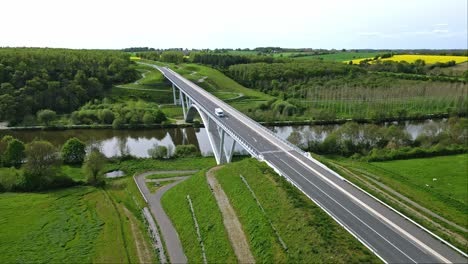 Camping-car-driving-on-Viaduct-crossing-Mayenne-river-in-Chateau-Gontier-countryside,-France