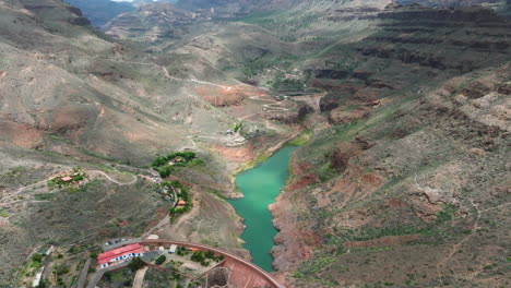 Fantastic-aerial-view-over-the-Sorrueda-dam-on-the-island-of-Gran-Canaria-on-a-sunny-day-with-nearby-mountains