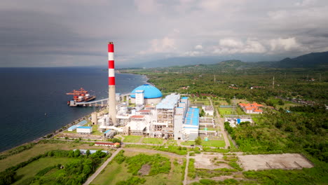 Aerial-pullback-view-of-Celukan-Bawang-Bali-power-plant-on-coastline,-Indonesia