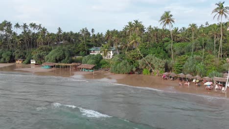 Panning-Drone-View-of-Lush-Jungle-and-Sandy-Beach-in-Sri-Lanka