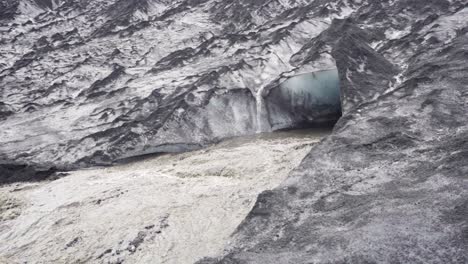 Water-flowing-out-of-a-hole-in-a-glacier-in-Iceland--Slow-motion