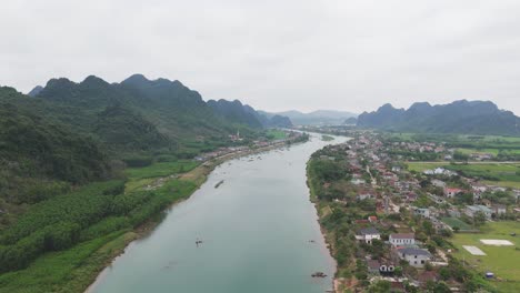 Aerial-footage-of-river-and-green-forest-with-mountain-natural-landscape-in-Vietnam,-India