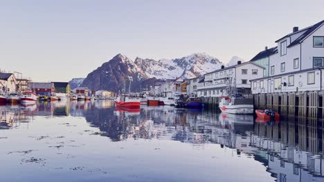 Quiet-Lofoten-fishing-village-at-dusk-with-calm-waters-and-mountain-backdrop