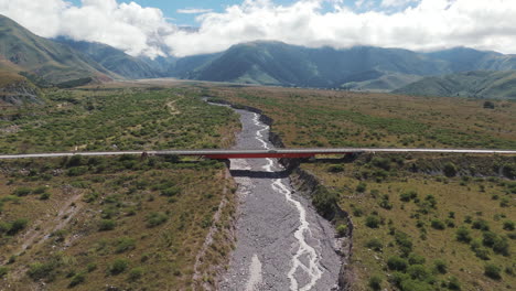 Luftaufnahme-Eines-Rasenden-Autos,-Das-Sich-Einer-Wunderschönen-Brücke-In-Jujuy,-Argentinien-Nähert