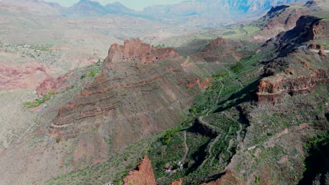 Aerial-view-of-the-Ansite-fortress-on-the-island-of-Gran-Canaria-on-a-sunny-day-and-seeing-a-palm-grove