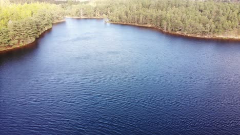 Aerial-View-Of-Loch-an-Eilein-Surrounded-By-Pines-Of-Rothiemurchus-Forest