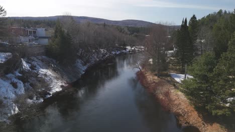 Aerial-of-river-in-snowy-forest-white-landscape-in-saint-come-Quebec-Canada-travel-destination