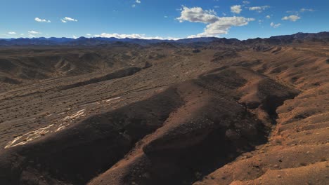 Flying-Over-Red-Sand-Desert-In-Nevada-Toward-Dry-Riverbed