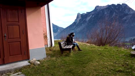 African-Tourist-in-Upper-Austria,-near-Chapel-on-Kalvarienberg-overlooking-Traunsee-lake-in-Ebensee,-Salzkammergut-region,-serene-mountain-backdrop