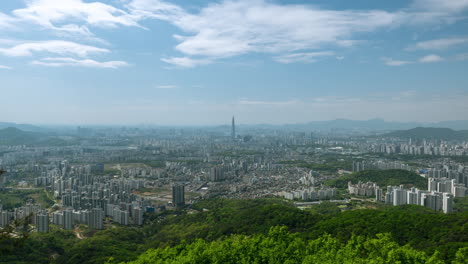 Seoul-city-skyline-with-clouds-movement-timelapse-in-spring,-view-of-Lotte-World-Tower-from-mountain-top-of-Namhansanseong-Fortres