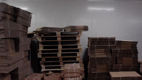 Cardboard-packaging-and-labeled-boxes-neatly-stacked-in-a-warehouse