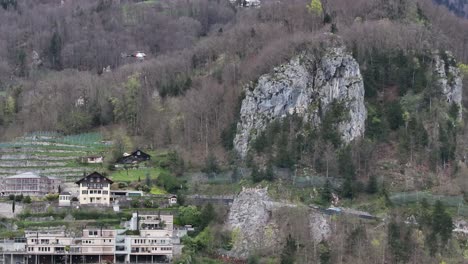 Helicopter-maneuvers-over-the-idyllic-Swiss-landscape-near-Weesen,-Walensee