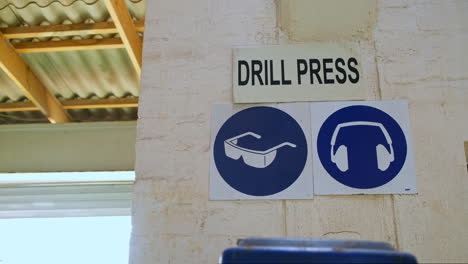 Blue-caution-signs-for-ear-and-eye-protection-with-drill-press-signage