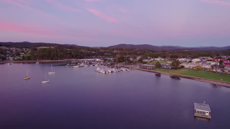 Aerial-establishing-pink-sky-over-small-marina-Saint-Helens,-Tasmania
