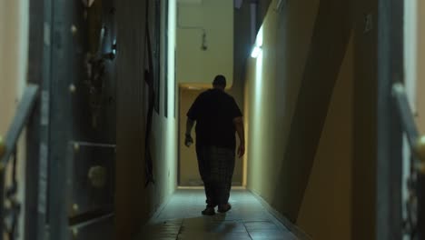 Arab-man-walking-threw-dark-hallway